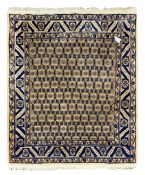 Iranian beige ground rug, with all over blue floral design on brown field, guarded border,