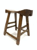 18th century primitive farmhouse stool, dished block seat raised on four splayed legs,