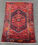 Persian Hamadan red ground rug, lozenge medallion on red field,