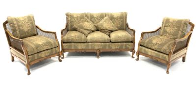 Early 20th century walnut and bergere lounge suite, comprising of a three seat sofa,
