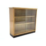 Mid 20th century maple bookcase with sliding glass doors, two adjustable shelves,