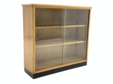 Mid 20th century maple bookcase with sliding glass doors, two adjustable shelves,