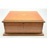 Late Victorian oak cutlery box with lifting top and fold out sides partly fitted with twelve fish