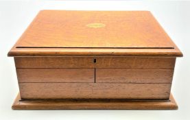 Late Victorian oak cutlery box with lifting top and fold out sides partly fitted with twelve fish