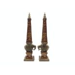 Pair of contemporary Chinese pottery obelisks with animals and foliage on a red ground and with