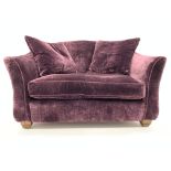 Christopher Pratt's snuggler sofa upholstered in purple velvet fabric, block supports,