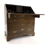 George III oak bureau, fall front revealing interior fitted with cubby holes, drawers and cupboard,