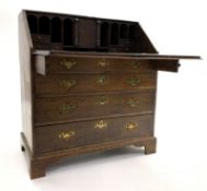 George III oak bureau, fall front revealing interior fitted with cubby holes, drawers and cupboard,