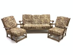 Ercol old colonial Yorkshire elm three piece lounge suit, comprising two easy armchairs,