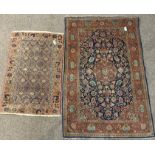 Persian design red ground rug, floral medallion surrounded by trailing foliate on blue field,