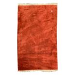 Chinese woollen red carpet, central medallion on red field, scrolled floral spandrels,