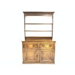 Georgian oak welsh dresser, projecting cornice and carved frieze over three hight plate rack,