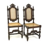 Pair Charles II style oak hall chairs, cresting rail carved with lion mask,