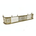 Late Victorian pierced brass fire curb with urn finials,