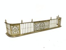 Late Victorian pierced brass fire curb with urn finials,