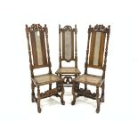 Pair of Charles II beech framed hall chairs, carved cresting rail, cane panel seat and back,