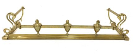 Edwardian brass fire curb with scroll ends,