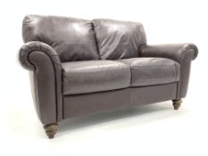 'Italsofa' two seat sofa, upholstered in brown leather, turned stained beech feet,