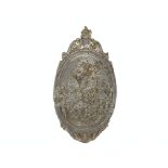 Oval lead plaque decorated in relief with cherubs beneath an urn finial, H69cm,