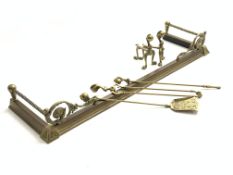 Set of three brass fire irons with claw and ball finials,