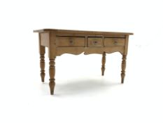 Victorian pine side table, three frieze drawers with glass handles, shaped apron, turned supports,