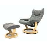 Ekornes Stressless reclining armchair and matching footstool upholstered in grey leather,