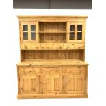 Large solid pine dresser, moulded cornice above two open shelves, two glazed doors and six drawers,