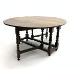 18th century oak drop leaf gate-leg dining table, oval top raised on turned supports,