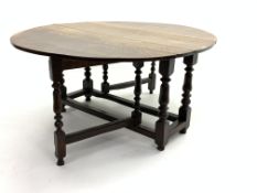 18th century oak drop leaf gate-leg dining table, oval top raised on turned supports,