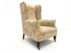 19th century Georgian design wing back armchair, upholstered in cream floral fabric,