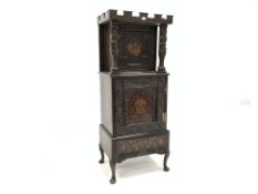 19th century oak cupboard, reconstructed with inlaid panel doors beneath a castellated frieze,