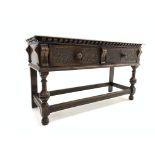 Early 20th century oak dresser side table, rectangular moulded top above two carved frieze drawers,