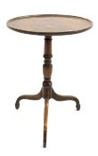 Georgian mahogany tilt top occasional table, circular top with raised edge above ring turned column,