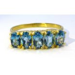 Silver-gilt five stone blue topaz ring,