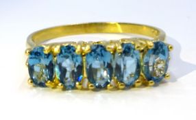 Silver-gilt five stone blue topaz ring,