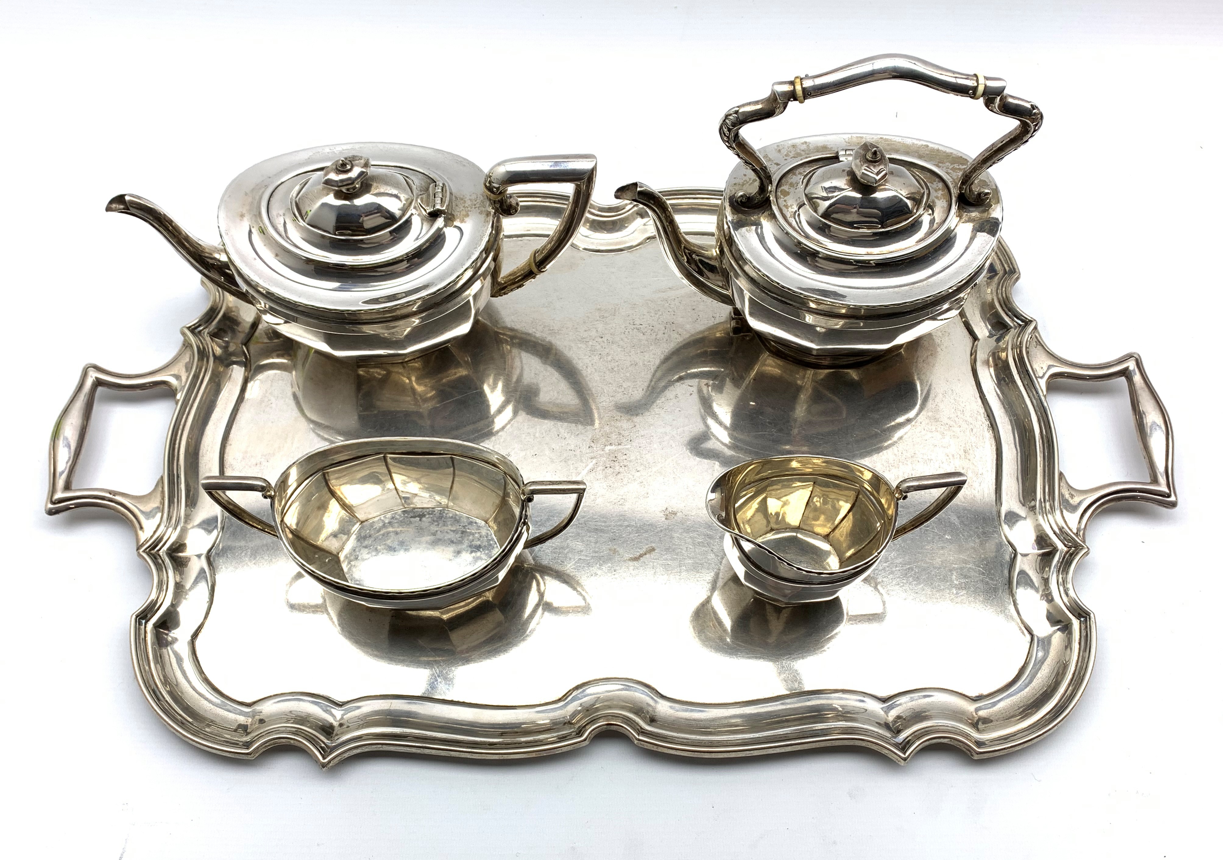 Silver four piece tea set of panel sided design comprising teapot, kettle,