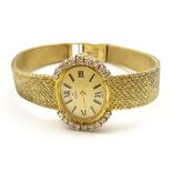 Ebel 9ct gold ladies manual wind wristwatch, the bezel set with nine diamonds on each side,