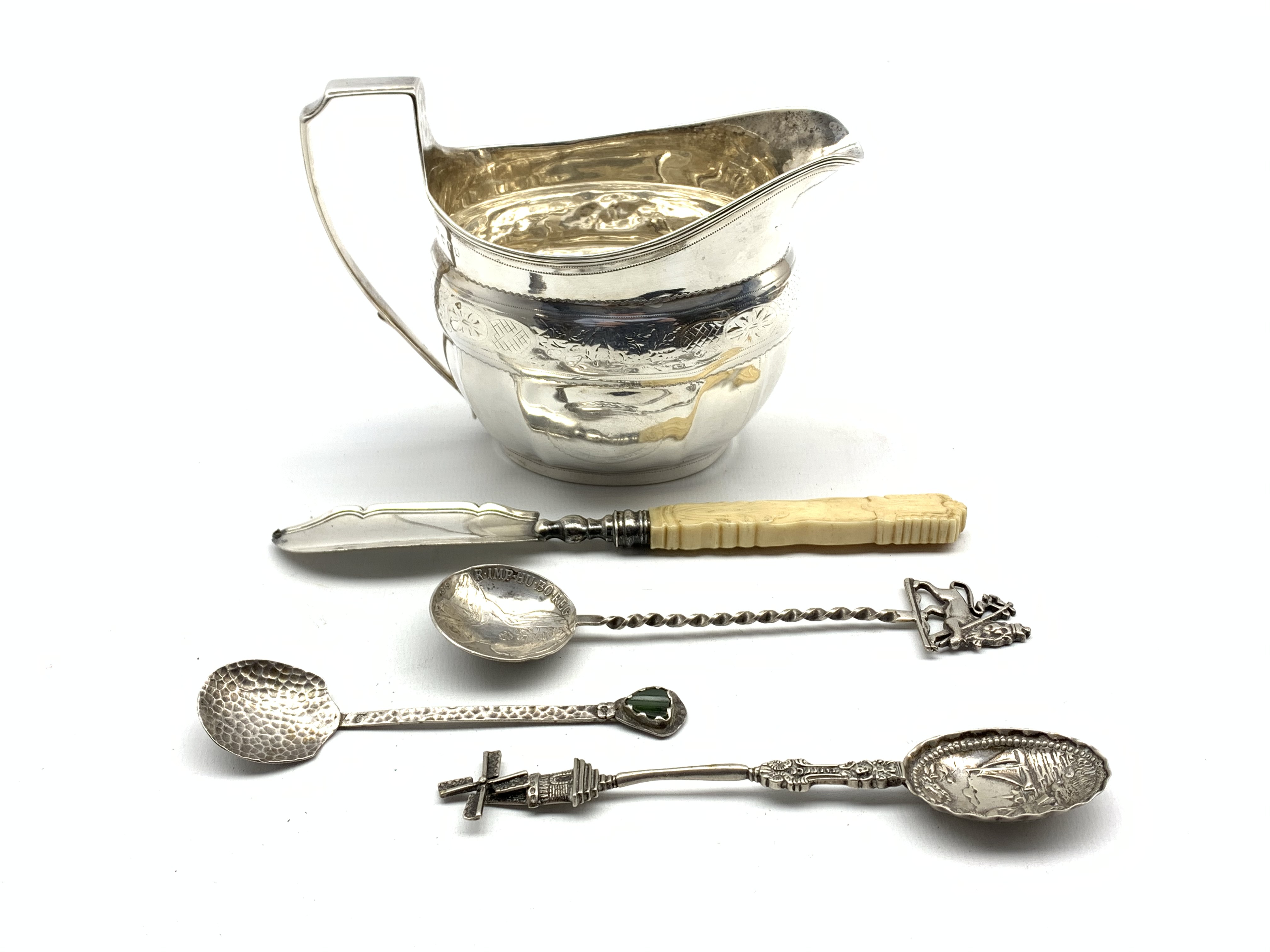 George III silver cream jug with engraved decoration and angular handle,