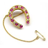 Early 20th century gold ruby and old cut diamond horseshoe brooch Condition Report &