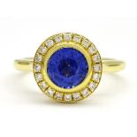 18ct gold round sapphire and brilliant cut diamond halo cluster ring, stamped 750,