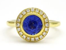 18ct gold round sapphire and brilliant cut diamond halo cluster ring, stamped 750,