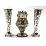 George III silver cream jug with embossed floral decoration,