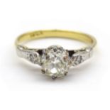 Gold old cut diamond ring, the central diamond of approx 0.