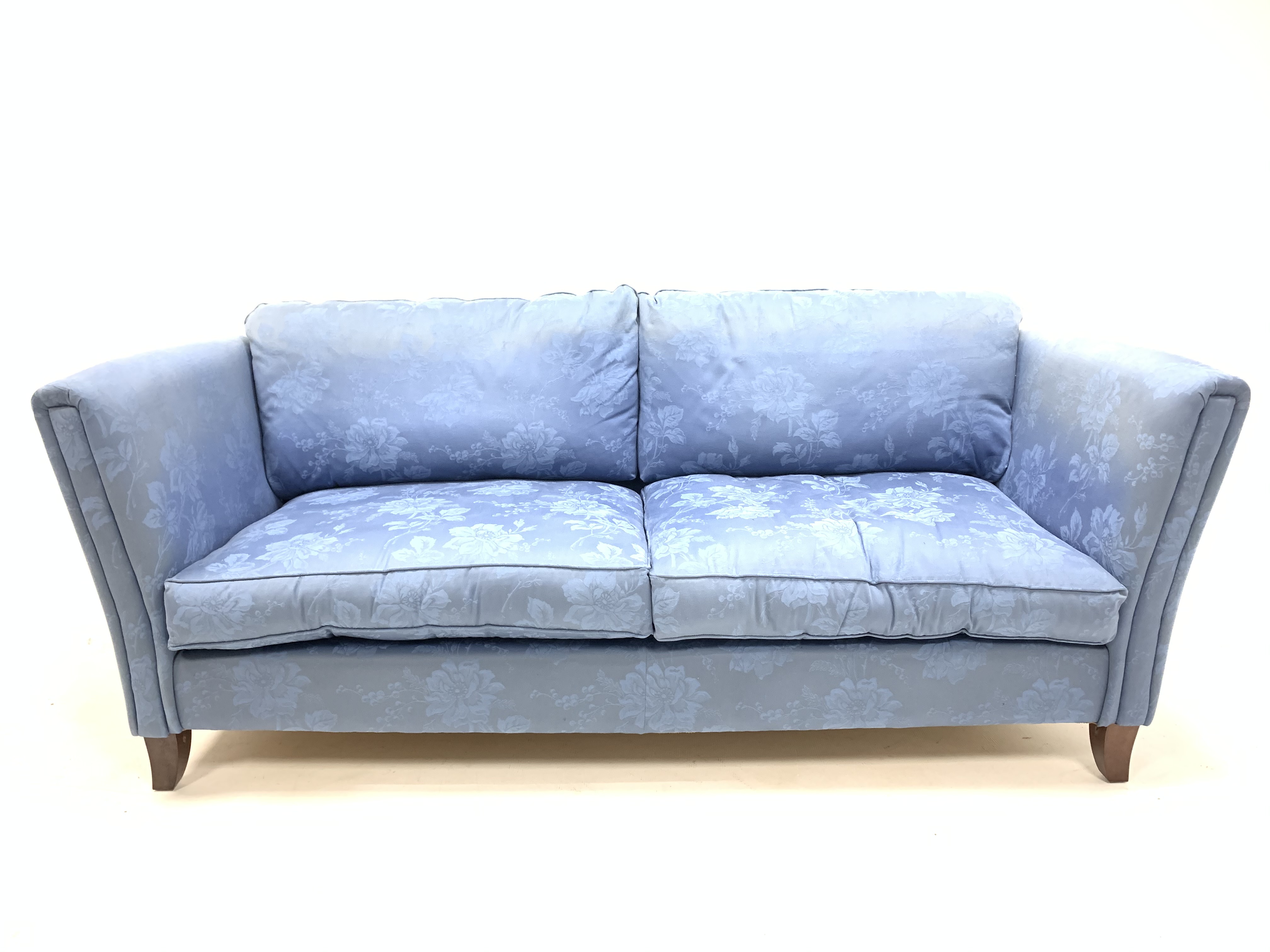 Laura Ashley three seat sofa upholstered in blue fabric, raised on square splayed walnut supports,