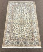 Persian ivory ground rug, decorated with scrolling foliage and central medallion,