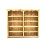 20th century pine open bookcase, rectangular moulded top above shaped apron,