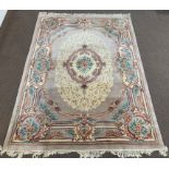 Chinese wool beige ground carpet with centrail medallion and all over stylised floral design,