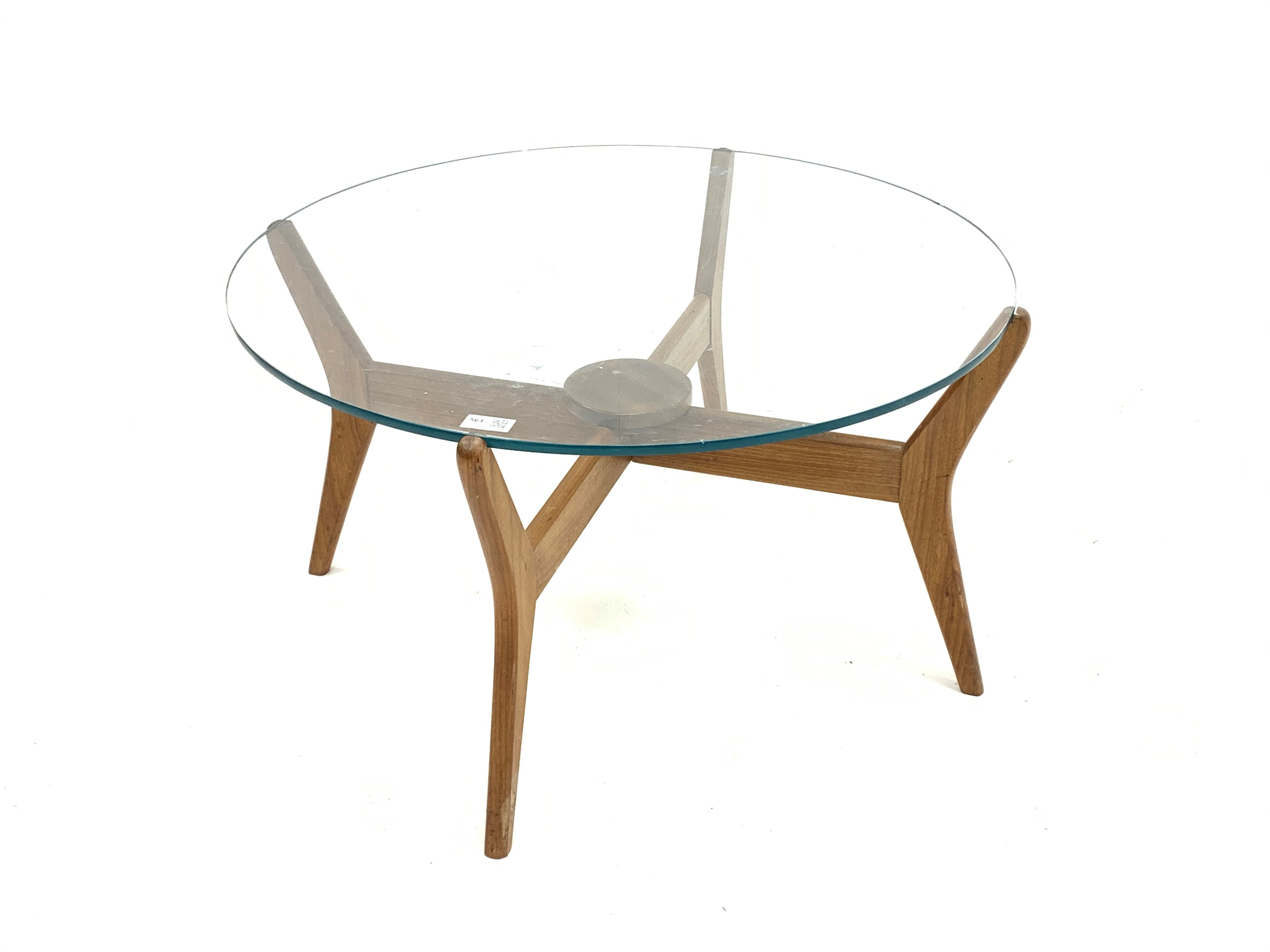 Mid century teak coffee table, with circular glazed top raised on cruciform base,