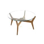 Mid century teak coffee table, with circular glazed top raised on cruciform base,