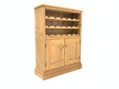 20th century pine side cabinet, with three tier wine rack over double panelled cupboards,